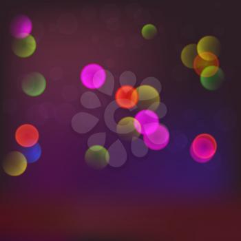 Abstract blurred background with bokeh effect and glowing colored spots.