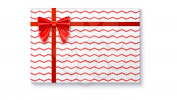Gift box with big red bow and ribbon, isolated on white background. Top view on gift packaged in a paper with pattern