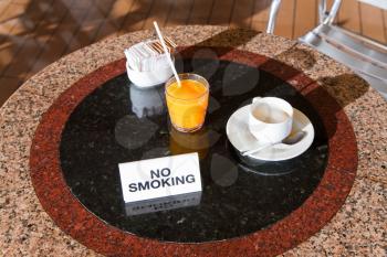 fresh orange juice and cappuccino on no smoking table in outdoor cafe on cruise liner