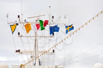 flags on navigation antenna of cruise liner