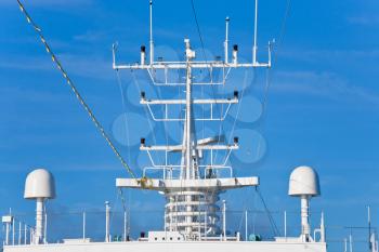 navigation antenna of cruise liner with blue sky on background
