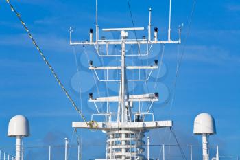 navigation antenna of cruise liner with blue sky on background