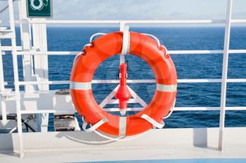 red life buoy on side of sea cruise liner