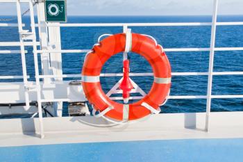 red life buoy on side of sea cruise liner