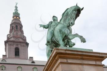 statue King Frederik the VII on Christiansborg Slotsplads and tower on Christiansborg palace in Copenhagen