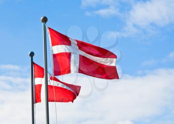 danish flags with blue sky on background