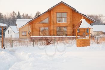 new wood country house in snowdrifts in winter