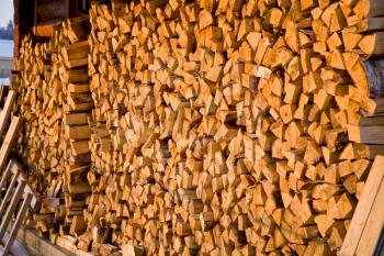 stack of firewood in village in winter