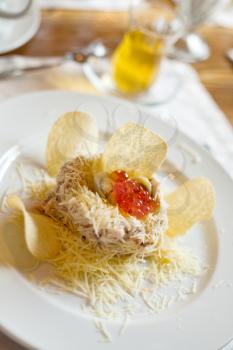 appetizer with quail egg, meat, ham, grated cheese, red caviar