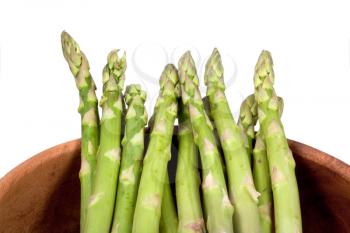 fresh green asparagus in wooden bowl