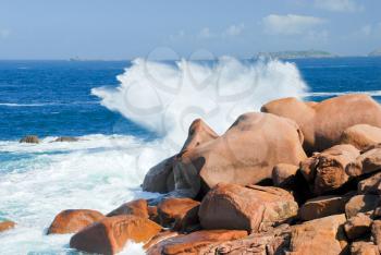 sea wave breaks against the rocks on Pink Granite Coast in France