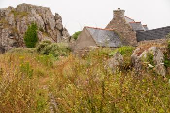 country Breton house between rocks in Brittany, France