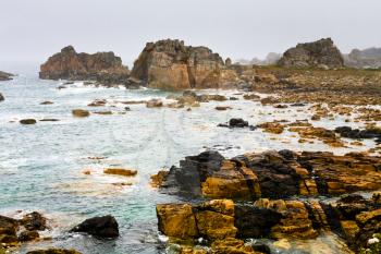 stone coastline of Atlantic ocean in Brittany in rainy day