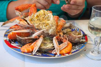 plate with cut crab,oysters,shrimps and other seafood