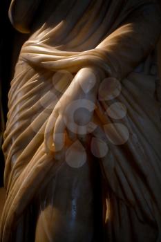 marble woman hand is lighted by pink beam