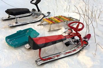 sleigh,snow scooters, ice-boat parked on snow hill 