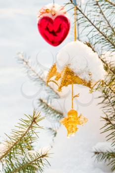 Christmas-tree decorations on tree under snow outdoor