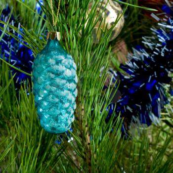 blue glass cone and balls and tinsel on Christmas-tree