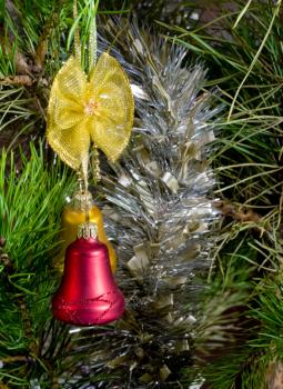 two red glass bells and tinsel on Christmas-tree
