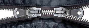 metal double zipper lock in unzip leather jacket. close-up