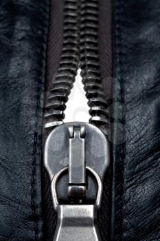 metal zipper lock in black leather jacket. close-up