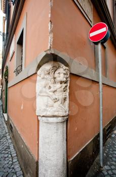 antique column in corner of medieval house, Rome, Italy