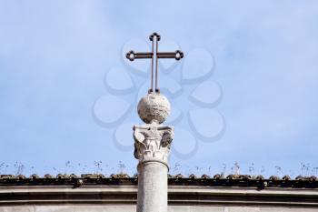 metal medieval cross on blue sky in Rome, Italy