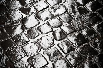 wet ancient cobblestones on old Rome city road