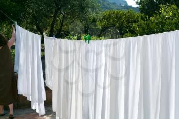 drying of white linens on air in summer day