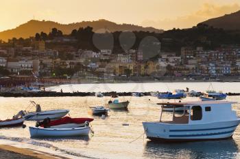 boats at sunset, near town Taormina, Sicily, Italy