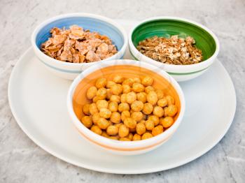 plate with three kind of cereals for breakfast on marble table