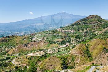 view on Etna and agricultural gardens on flank of hills in Sicily