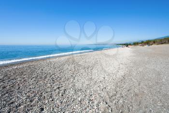 black pebble and sand beach San Marco on Ionian Sea in Sicily