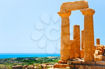 view on Dorian columns of Temple of Juno and sea coast in Valley of the Temples in Agrigento, Sicily