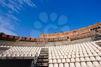 modern seats in outdoor antique amphitheatre Teatro Greco, Taormina, Sicily