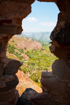 view on lands through loophole in old Arab-Norman fortress Castello di Calatabiano, Sicily