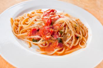 spaghetti with spicy tomato sauce on white plate