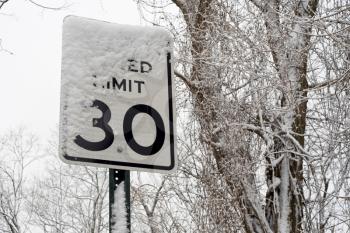 road sign of limit of speed under snow