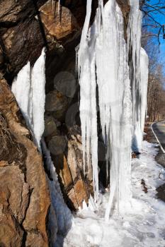icicle on road - frozen stream in winter