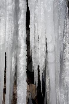 frozen stream in winter. icicles in cleft