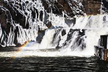 rainbow on river waterfall in winter day