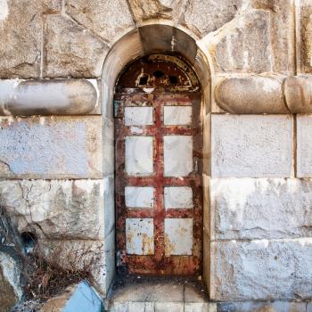 old rusty door in stone wall