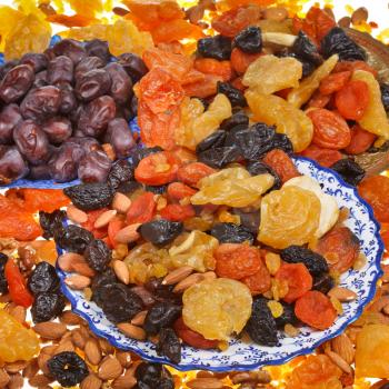 many sweet dried fruits on asian plates