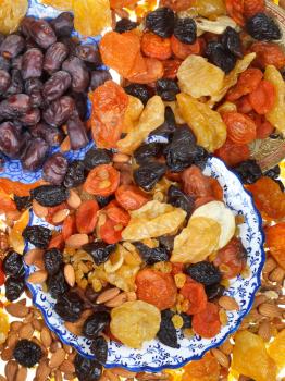 top view of sweet dried fruits on asian plates