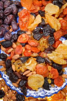 dried fruits on asian plates close up