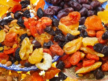 many dried sweet fruits on asian plates