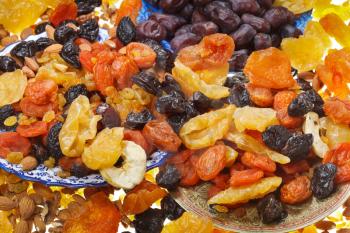 lot of dried sweet fruits on asian plates