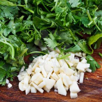 fresh spicy herbs - finely chopped cloves of garlic and sprig of parsley and cilantro