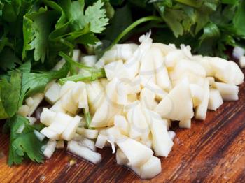 fresh spicy greens - chopped garlic and sprig of parsley and cilantro close up