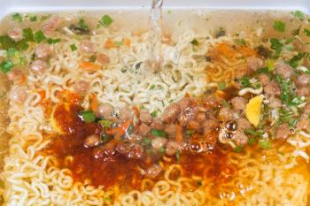 cooking of instant noodles close up